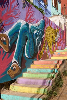 Colourfully decorated houses and steps on Templeman, a historic street in the UNESCO World Heritage port city of Valparaiso, Chile.