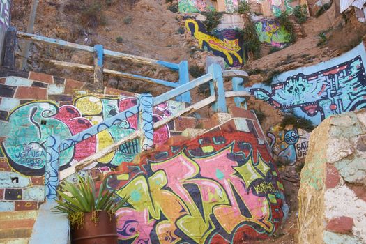 Colourfully decorated path leading up a hillside in the UNESCO World Heritage port city of Valparaiso, Chile.