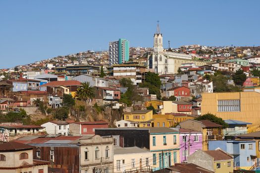 Colourfully decorated houses crowd the hillsides of the historic port city of Valparaiso in Chile.
