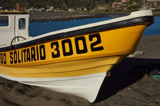 Colourful fishing boat on the beach in the small fishing village of Curanipe in the Maule Region of Chile.