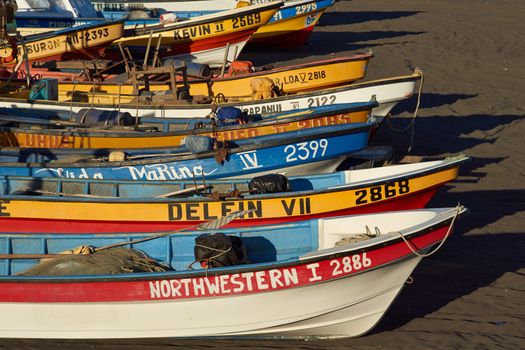 Colourful fishing boats on the beach in the small fishing village of Curanipe in the Maule Region of Chile.