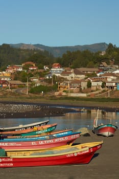 Colourful fishing boats on the beach in the small fishing village of Curanipe in the Maule Region of Chile.