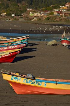 Colourful fishing boats on the beach in the small fishing village of Curanipe in the Maule Region of Chile.