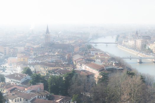 Panorama of Verona (Italy) in the fog. The city of Romeo and Juliet in a foggy winter day.