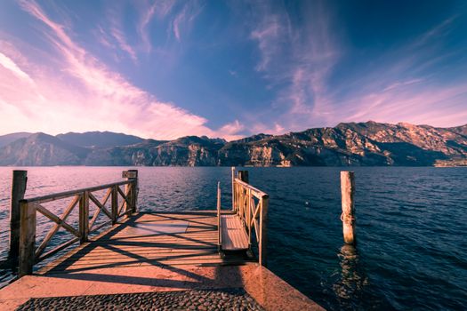 Walkway over the Lake Garda near Malcesine at sunset.