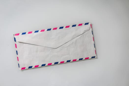 A top view shot of a mail envelope taken on a white background.