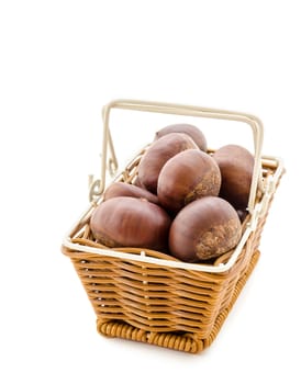 Sweet chestnut in weave basket on white background