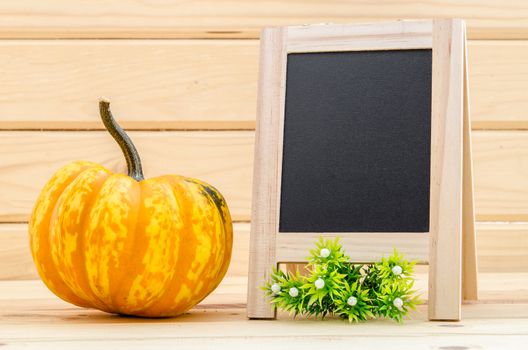 pumpkin with a blank chalk board for your text in wood room.