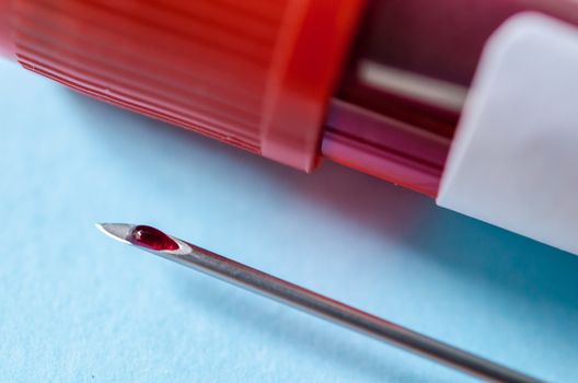 Close up blood in needle with blood tube for test in laboratory.