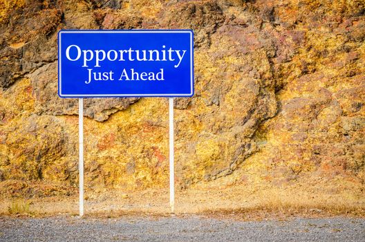 Opportunity, Just Ahead Green Road Sign at cliff