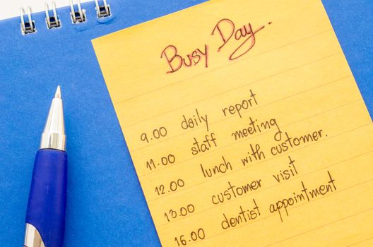 business hand writing appointment schedule on paper note.