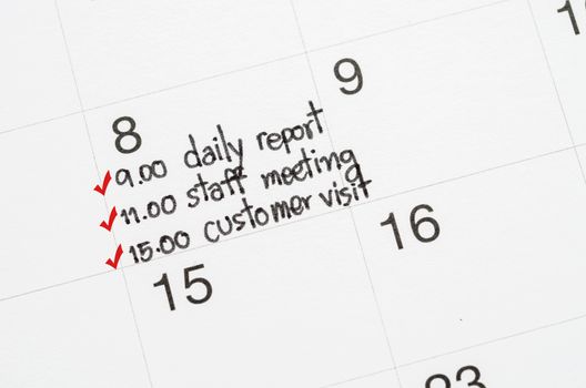 The red check mark with to do list on page calendar. Busy day concept.
