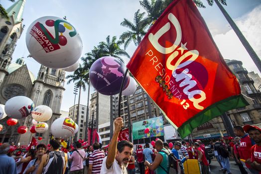 BRAZIL, Sao Paulo: A protester holds a banner reading Dilma president as hundreds protest in support of Brazil's President Dilma Rousseff and former President Luiz Inacio Lula da Silva at the Se Square, in Sao Paulo, southeastern Brazil, on March 31, 2016. Rousseff is currently facing impeachment proceedings as her government faces a stalling national economy and multiple corruption scandals. 