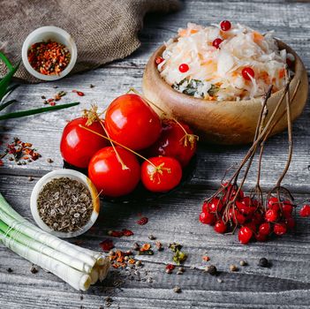 Set of pickled cabbage and salted tomatoes in a rustic style