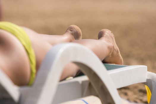 Part of the deck chairs on the beach with legs