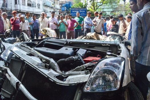 INDIA, Kolkata: Onlookers watch a crushed car as Indian rescue workers clear away debris amid efforts to free people trapped under the wreckage of a collapsed flyover bridge in Kolkata on April 1, 2016. Emergency workers in India battled to rescue dozens of people still trapped after a flyover collapsed onto a busy street, killing at least 22 people and injuring over 100 more.