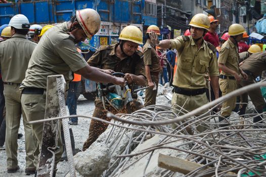 INDIA, Kolkata: Indian rescue workers clear away debris amid efforts to free people trapped under the wreckage of a collapsed flyover bridge in Kolkata on April 1, 2016. Emergency workers in India battled to rescue dozens of people still trapped after a flyover collapsed onto a busy street, killing at least 22 people and injuring over 100 more.