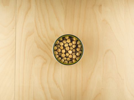 Top view of open tin can with chickpeas, simple dieting illustration