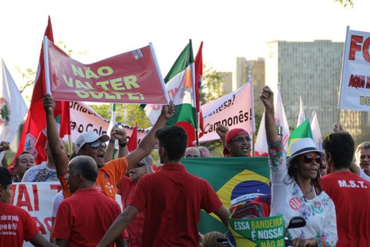 BRAZIL, Brasília : Unionists and Worker's Party (PT) supporters demonstrate in support of President Dilma Rousseff and former President Luiz Inacio Lula da Silva in front of the Congress in Brasilia on March 31, 2016. Brazil's Supreme Court on Thursday removed a politically explosive case against former president Luiz Lula Inacio da Silva from a crusading corruption judge. Judges voted to put Lula's case under the jurisdiction of the Supreme Court and not federal Judge Sergio Moro. Lula is accused of money laundering and concealing property in connection with a huge probe led by Moro into state oil company Petrobras. 