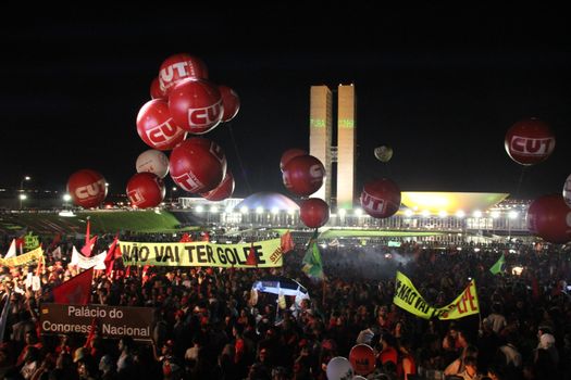 BRAZIL, Brasília : Unionists and Worker's Party (PT) supporters demonstrate in support of President Dilma Rousseff and former President Luiz Inacio Lula da Silva in front of the Congress in Brasilia on March 31, 2016. Brazil's Supreme Court on Thursday removed a politically explosive case against former president Luiz Lula Inacio da Silva from a crusading corruption judge. Judges voted to put Lula's case under the jurisdiction of the Supreme Court and not federal Judge Sergio Moro. Lula is accused of money laundering and concealing property in connection with a huge probe led by Moro into state oil company Petrobras. 