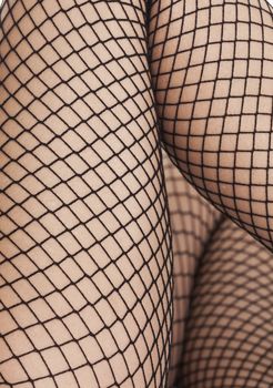 womans feet in fish net stockings