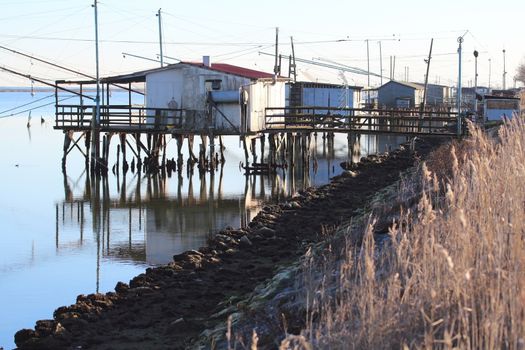 fishing huts with net on the canal of the lagoon