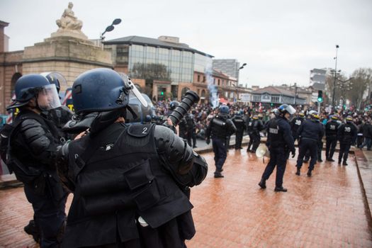 FRANCE, Toulouse:  French riot police officers surround protesters during a demonstration against the French government's planned labour law reforms on March 31, 2016 in Toulouse, southern France. France faced fresh protests over labour reforms just a day after the beleaguered government of President Francois Hollande was forced into an embarrassing U-turn over constitutional changes. 