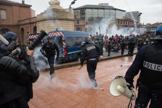 FRANCE, Toulouse:  French riot police officers fire tear gas at protesters during a demonstration against the French government's planned labour law reforms on March 31, 2016 in Toulouse, southern France. France faced fresh protests over labour reforms just a day after the beleaguered government of President Francois Hollande was forced into an embarrassing U-turn over constitutional changes. 