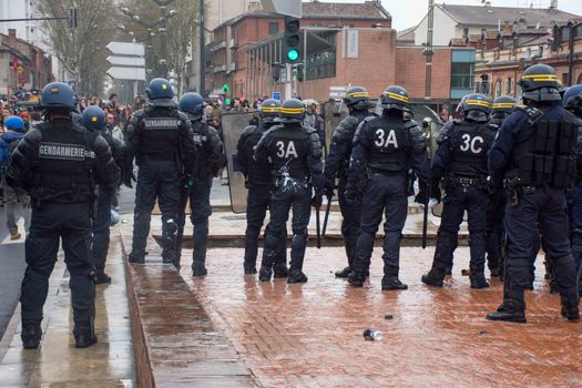 FRANCE, Toulouse:  French riot police officers surround protesters during a demonstration against the French government's planned labour law reforms on March 31, 2016 in Toulouse, southern France. France faced fresh protests over labour reforms just a day after the beleaguered government of President Francois Hollande was forced into an embarrassing U-turn over constitutional changes. 