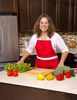 woman cooking with raw vegetables in the kitchen