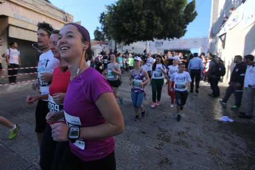 WEST BANK, Bethlehem: Women run through Bethlehem during the 4th annual Palestine Marathon on April 1, 2016.Runners from 64 countries ran through Bethlehem under the banner of the right to freedom of movement. Organizers said that more than 4,000 people registered for the event.