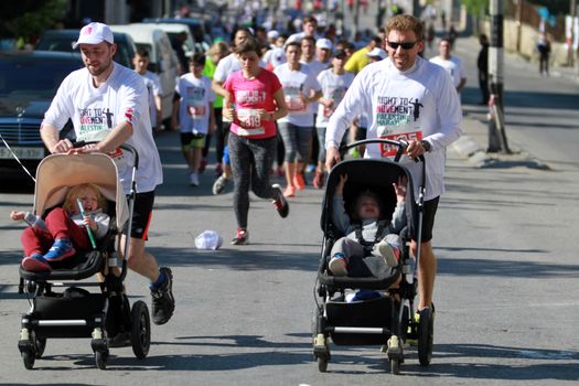 WEST BANK, Bethlehem: Runners push strollers during the 4th annual Palestine Marathon on April 1, 2016 in Bethlehem. Runners from 64 countries ran through Bethlehem under the banner of the right to freedom of movement. Organizers said that more than 4,000 people registered for the event.