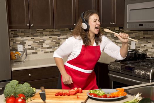 woman in the kitchen listening to music and singing