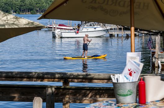 NAPLES, ME - JULY 30: man paddle on the ocean on July 30, 2014 in Naples, ME, USA