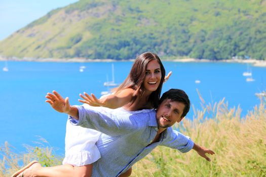 Cheerful couple having fun on vacation at seaside