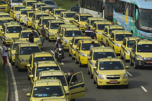 BRAZIL, Rio de Janeiro: Taxis block the street in Rio de Janeiro, Brazil on April 1, 2016. Taxi drivers are outraged that Uber, which does not have the authorization to operate in Rio, continues to do so under a court injunction. The demonstrators called for Uber to leave Brazil.