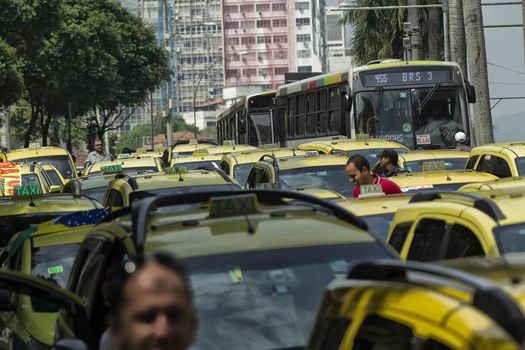 BRAZIL, Rio de Janeiro: Taxi drivers rally and block traffic in Rio de Janeiro, Brazil on April 1, 2016. Taxi drivers are outraged that Uber, which does not have the authorization to operate in Rio, continues to do so under a court injunction. The demonstrators called for Uber to leave Brazil.