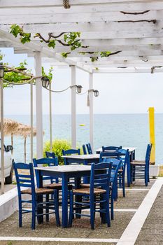 Empty mediterranean outdoor beach cafe, focus on closest table