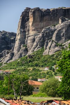 Edge of Kalambaka city with rocky mountains of Meteora at background