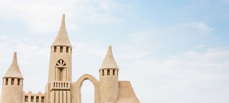 Grand sandcastle on the beach during a summer day