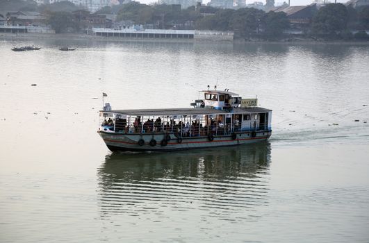 A boat crossing the Hoogly river in Kolkata during sunset