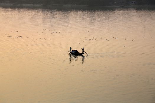 A boat crossing the Hoogly river in Kolkata during sunset