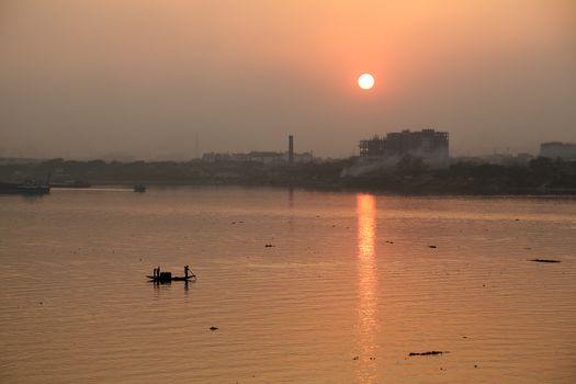 A boat crossing the Hoogly river in Kolkata during sunset