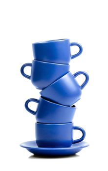 Five blue ceramic coffee cups placed one onto antoher.