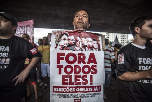BRAZIL, Sao Paulo: A protester holds a sign reading All of them out as hundreds of people demonstrate for the impeachment of President Dilma Rousseff and early elections at Avenida Paulista in Sao Paulo, southern Brazil, on April 1, 2016. Brazilian President Dilma Rousseff is facing possible impeachment by Congress. The effort comes amid an angry public mood over the South American nation's worst recession in decades and a big bribery scandal at the state oil company Petrobras. 