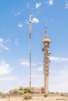 BLOEMFONTEIN, SOUTH AFRICA, DECEMBER 21, 2015: A microwave telecommunications tower and a TV and radio broadcast tower next to each other on Naval Hill. The broadcast tower was erected in 1963
