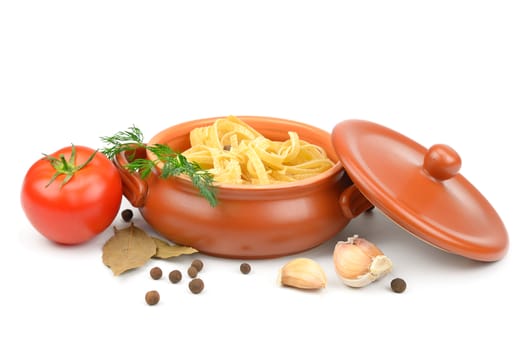 Clay pot with pasta, vegetables and spices isolated on white background.