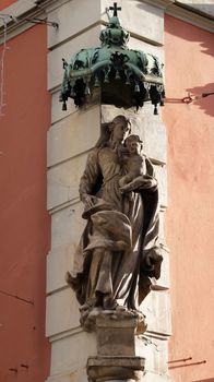 Virgin Mary with baby Jesus, statue on the house facade in Graz, Styria, Austria