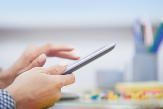 Hands of businessperson using digital tablet