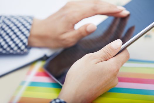 Hands of businessperson using digital tablet